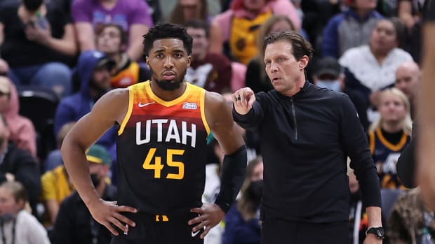 Utah Jazz guard Donovan Mitchell stands next to coach Quin Snyder.